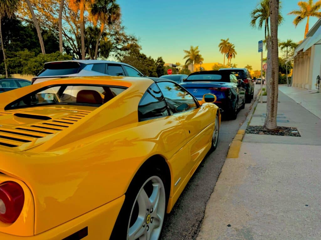 Palm Beach Island residential street with palm trees and luxury homes in South Florida