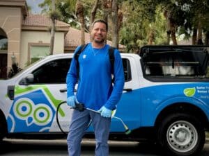 Licensed Wise House Pest Control technician with service vehicle — professional termite company Florida
