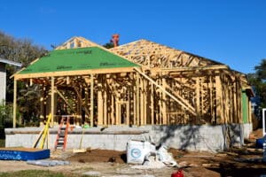 New home under construction in South Florida with exposed wood framing and a partially covered roof