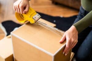 Sealing cardboard box with tape